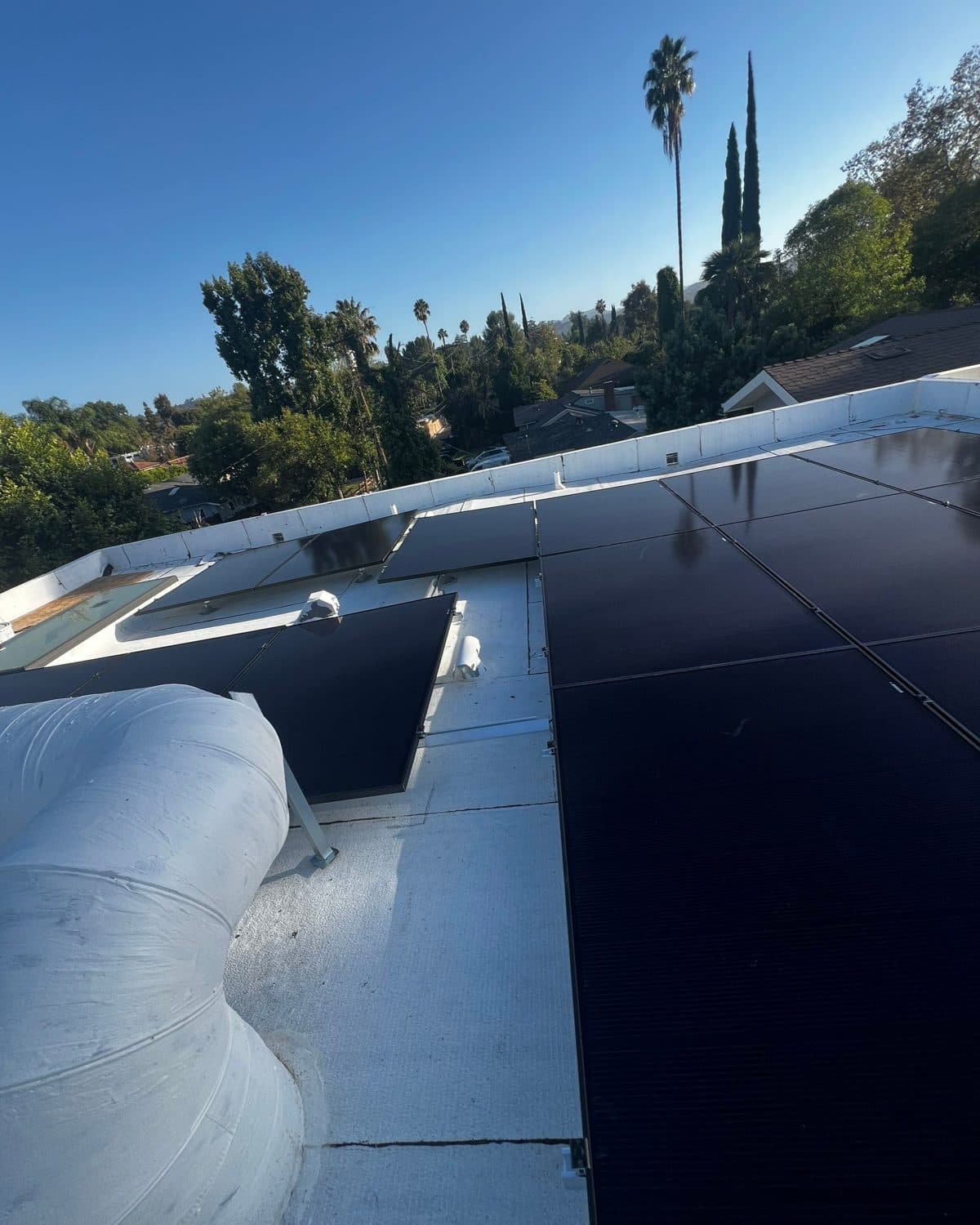 Solar modules on a flat roof in Woodland Hills, installed by AMECO Builders
